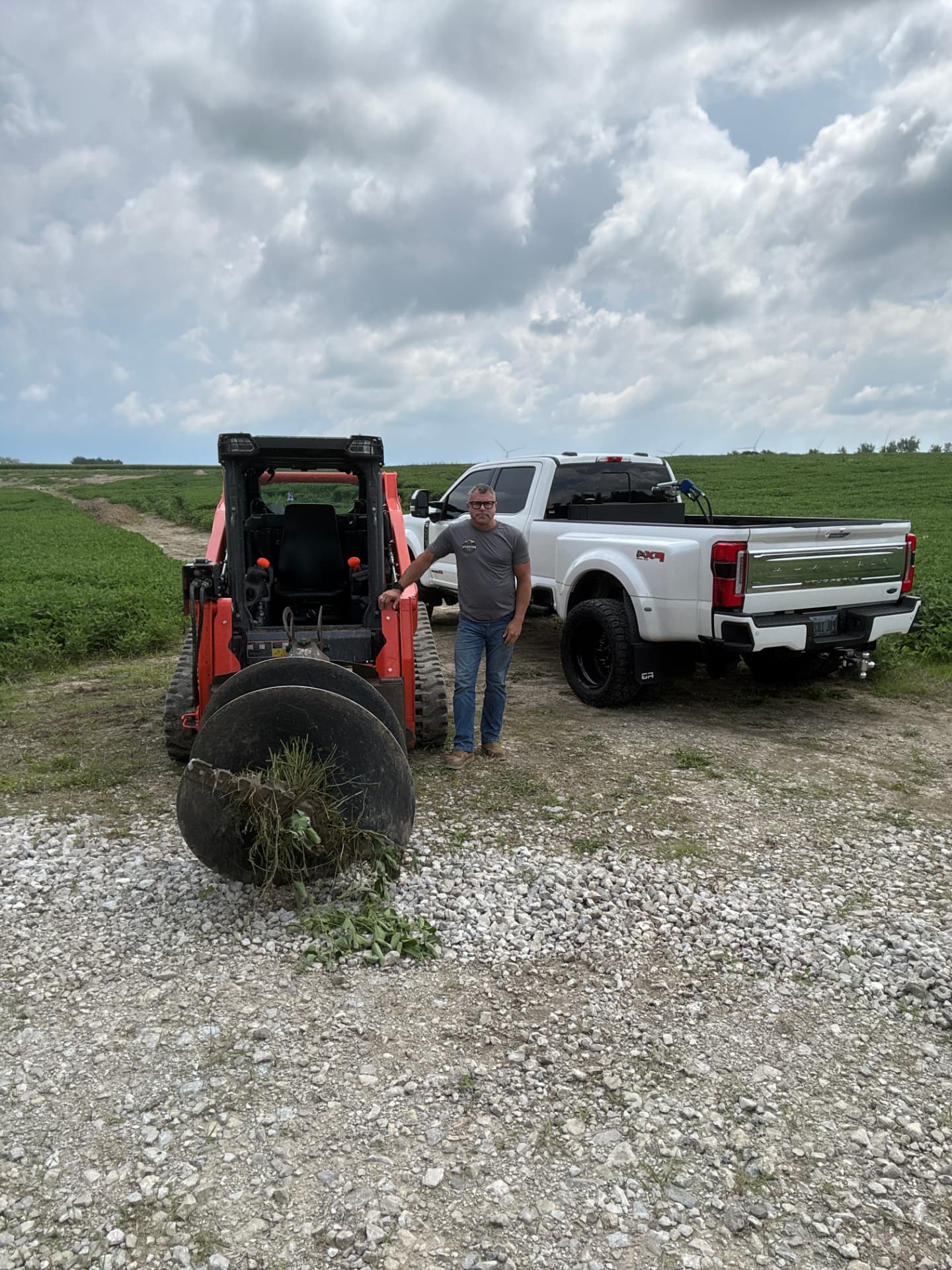 Frank Cumella with his Kubota skid steer and truck on a job site